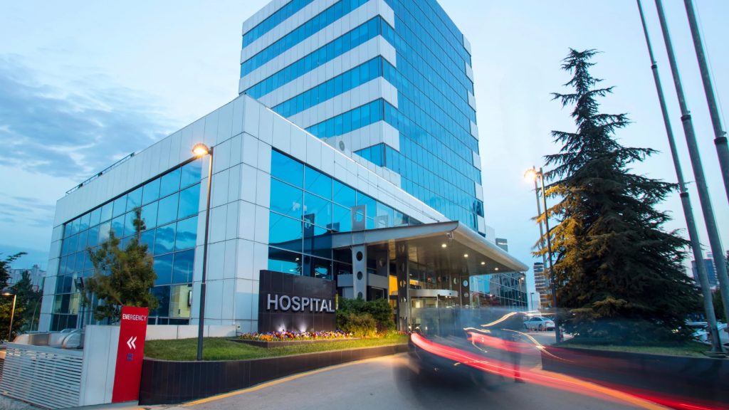 Hospital building and entrance at dusk.